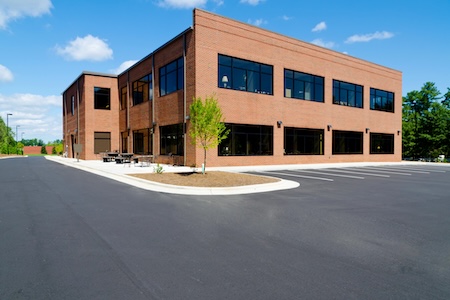 Commercial Building Washing in Coastal Texas: How to Remove Mildew Without Damaging Paint